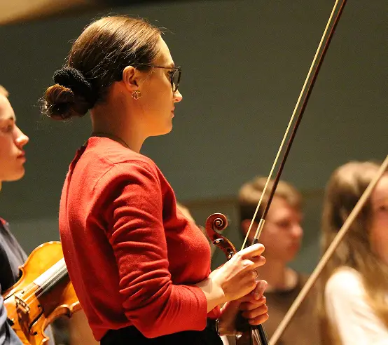 Agata Kawa-Cajler leading a string ensemble rehearsal